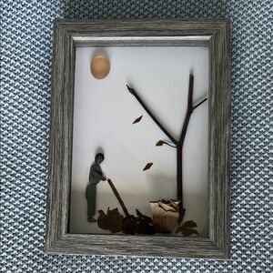 Framed Pebble Art with Man Raking Leaves